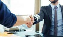 Men in corporate attire shaking hands